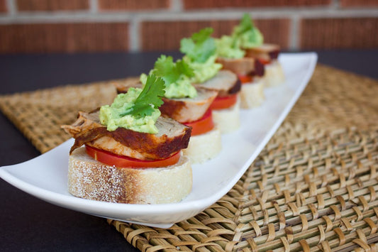 Pork and guacamole canapes on tray