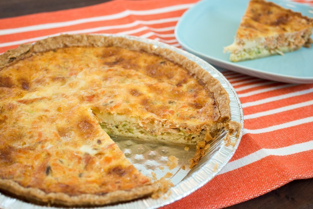 Smoked salmon quiche on red dishcloth